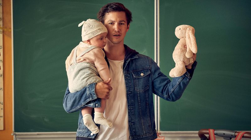 Der ehemalige Fußballprofi Timo (Tim Oliver Schultz) stellt sich mit Baby Lilly in der Schulklasse seiner Söhne mit der Berufsangabe "Vater" vor.
