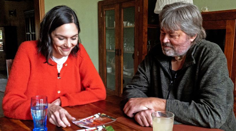 Frank Denecke zeigt Y-History-Reporterin Sophie Labitzke Bilder aus seiner Zeit als Raucher in den 1980ern und 1990ern. Wäre der Krebs nicht gewesen, würde er heute immer noch rauchen, erzählt er.
