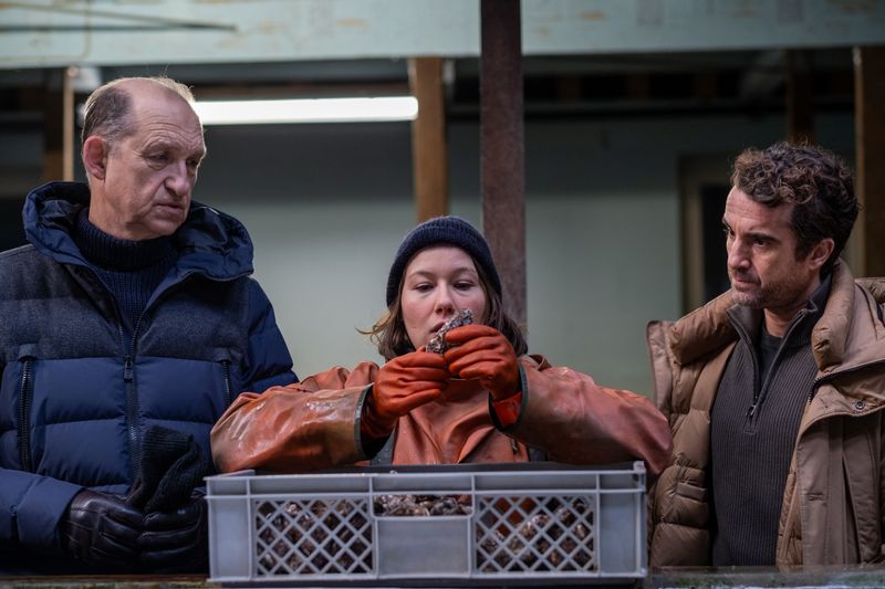 Tomke Bundis (Josefine Israel) hätte durchaus ein Mordmotiv. Immer wieder hatte sich das Opfer an ihren Austern bedient. Carl Sievers (Peter Heinrich Brix, links) und Hinnerk Feldmann (Oliver Wnuk) befragen sie.