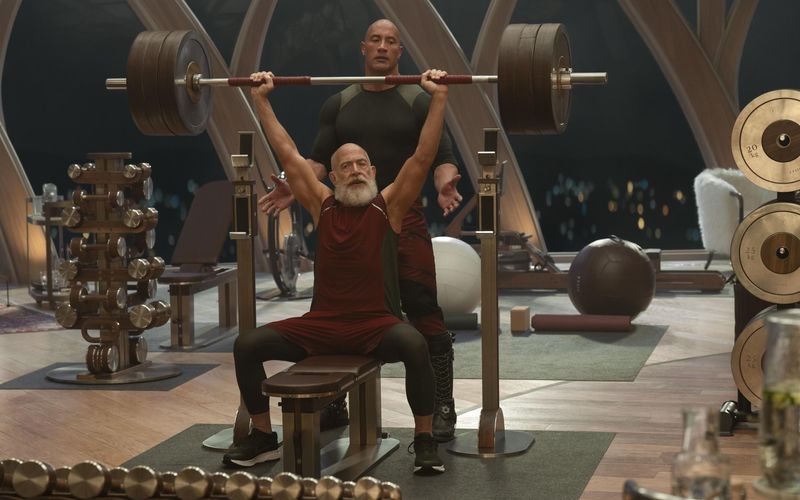 Der Weihnachtsmann (J. K. Simmons, vorne, mit Dwayne Johnson) beim Muskeltraining? Klar, wer so viele Geschenke durch die Gegend schleppt, braucht ja auch eine Menge Kraft.